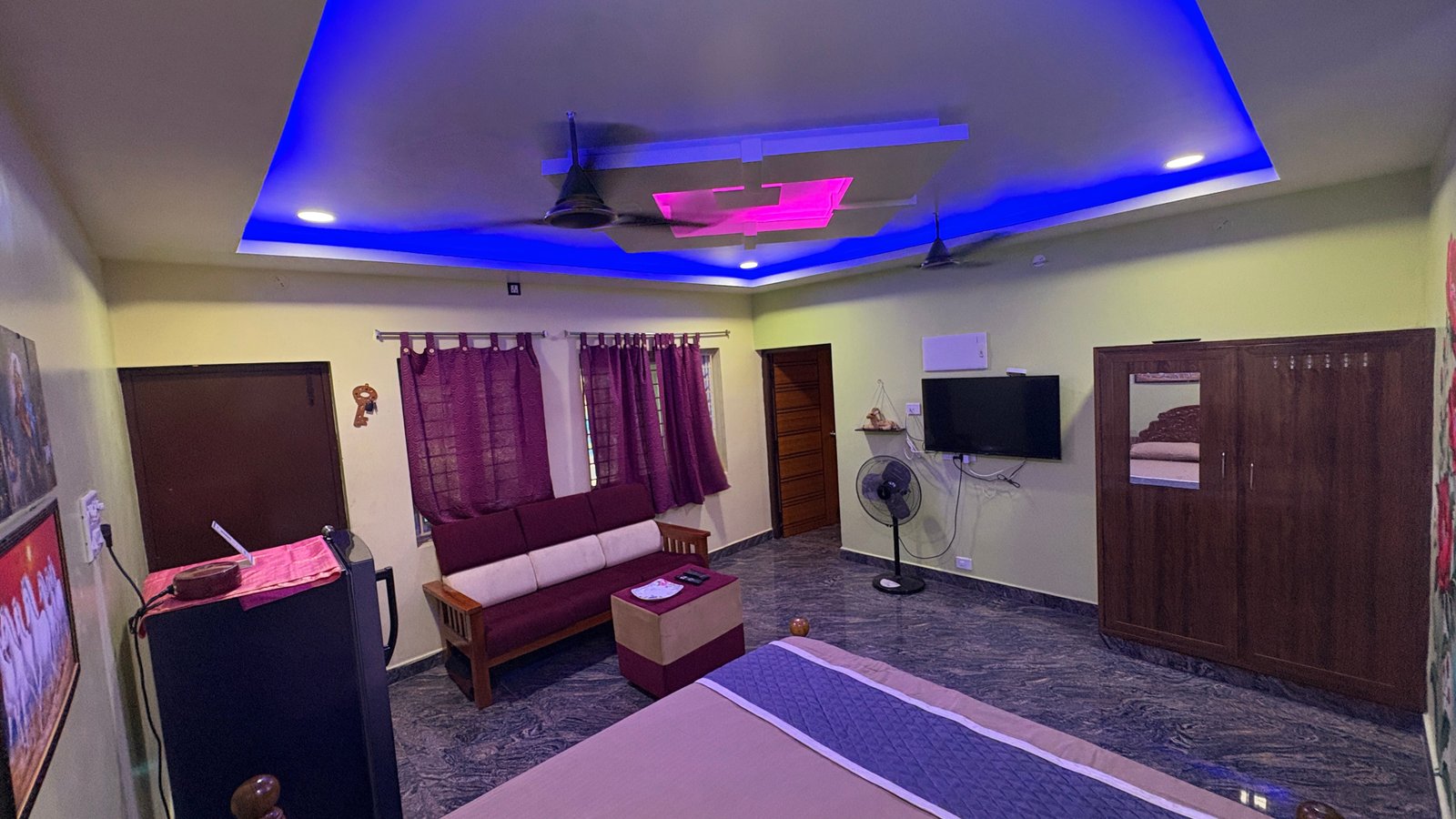Non-AC Cottage bedroom interior with ceiling fans and comfortable seating
